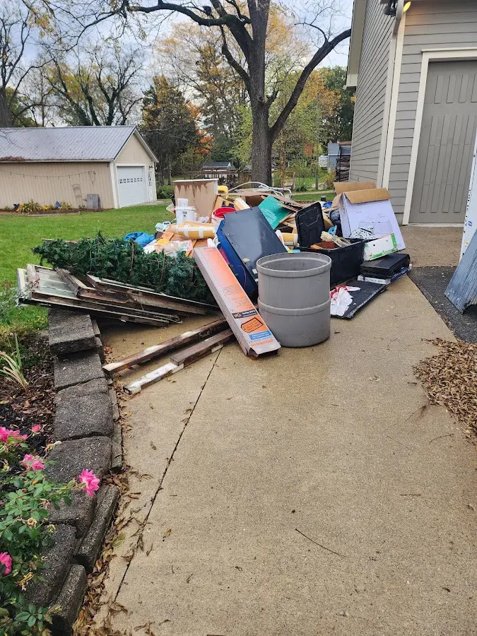 Dumpster being loaded with debris for Estate Cleanout Dumpster Rental in Petaluma